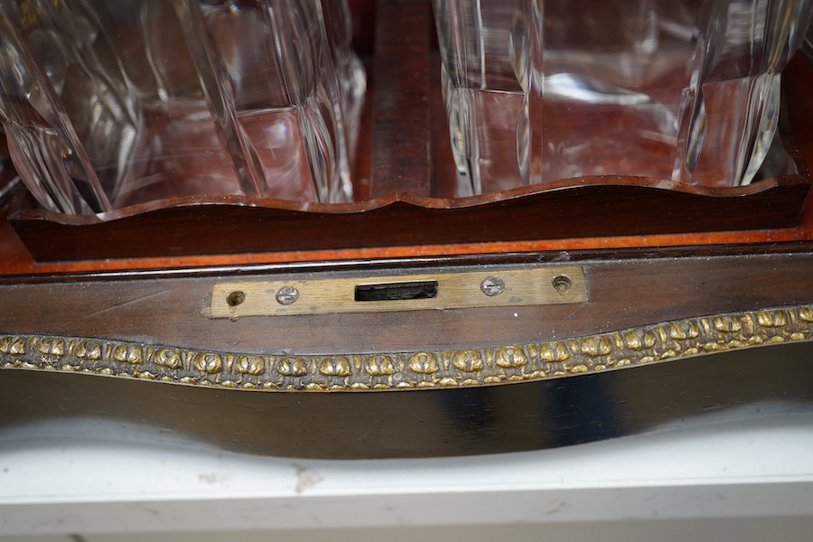 A 19th century Boulle panelled and decorative brass work liqueur cabinet, the interior fitted with gilt fitments, four cut glass decanters and sixteen liqueur glasses, 34cm wide, 26cm high. Condition - minor scratches to